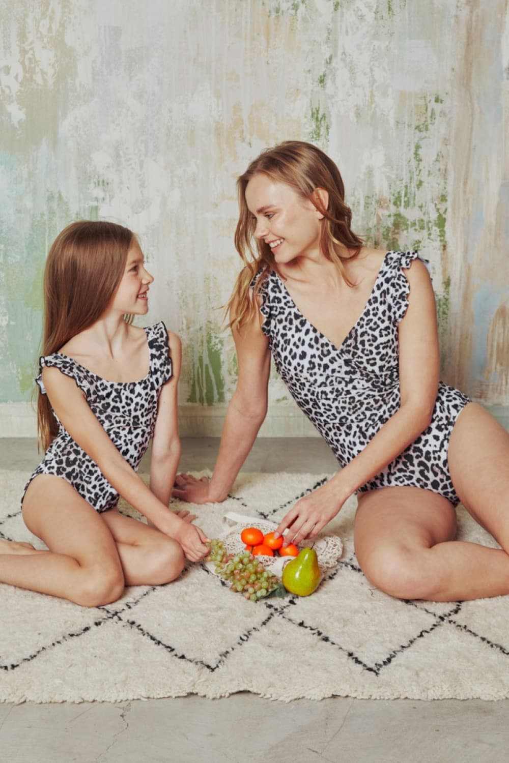 Leopard print one-piece swimsuits with ruffle accents, perfect for beach outings.