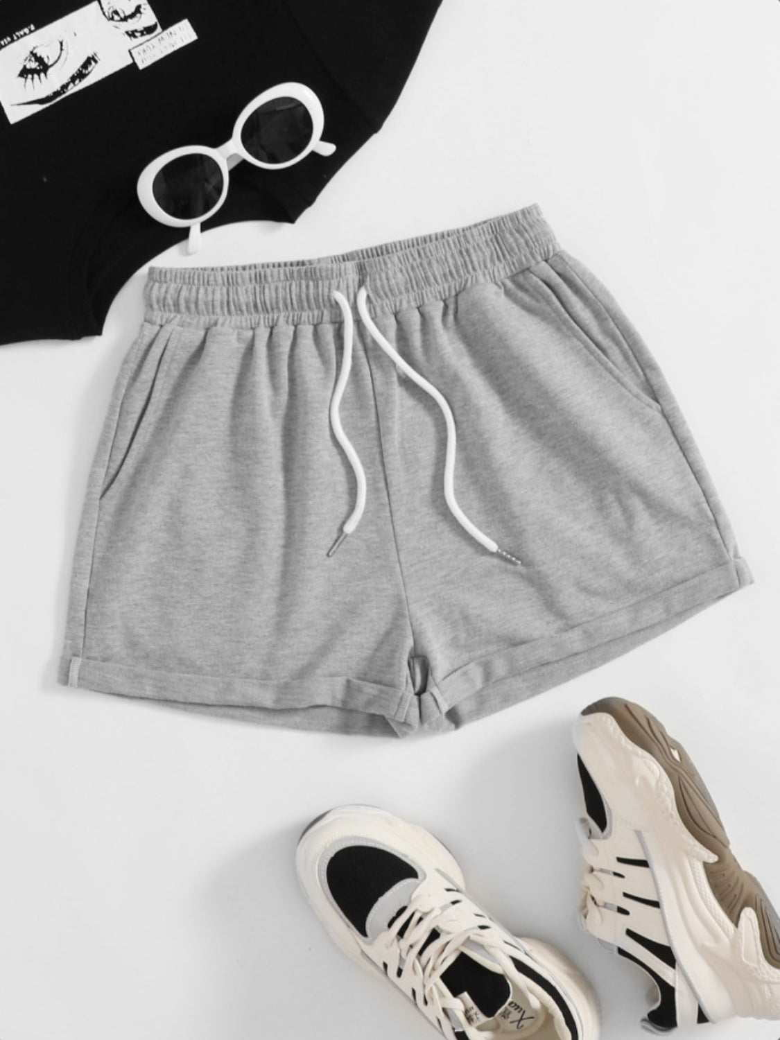 Gray drawstring pocketed elastic waist shorts made of 100% polyester.