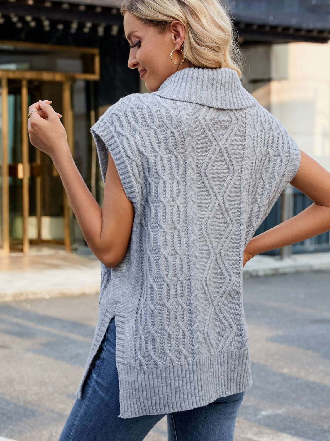 Side slit turtleneck sweater vest in gray with a cable knit pattern, slightly stretchy fabric.