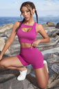 Two-piece fitness set with cutout crop top and sports shorts in solid color.