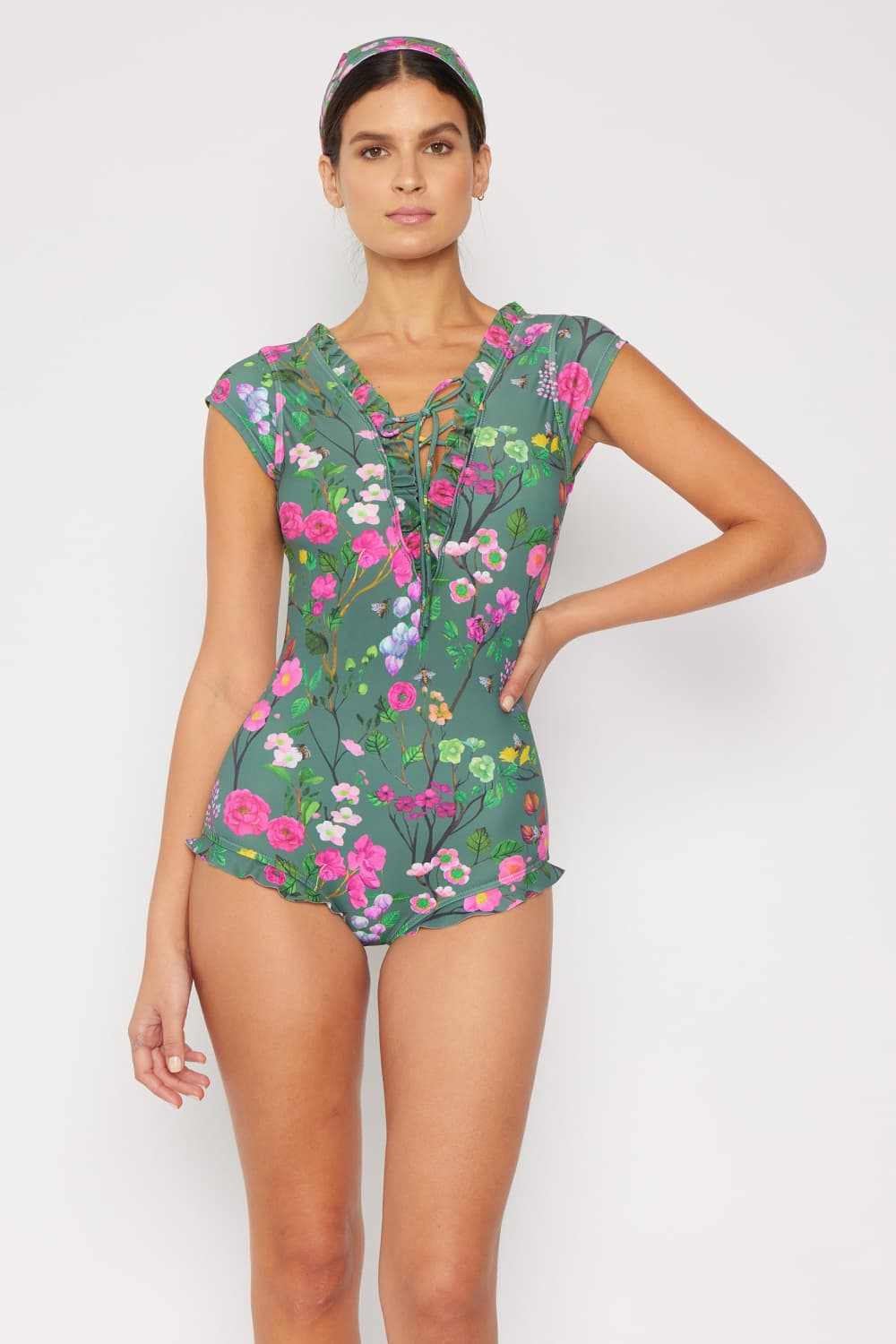 Marina West Swim floral V-neck one-piece swimsuit in sage with lace-up detail and ruffle features.