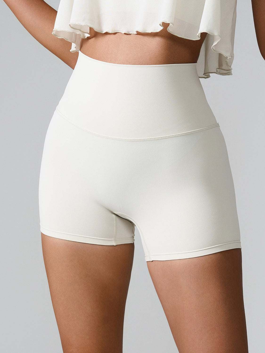 High waist active shorts with pockets in stretchy nylon-spandex blend.