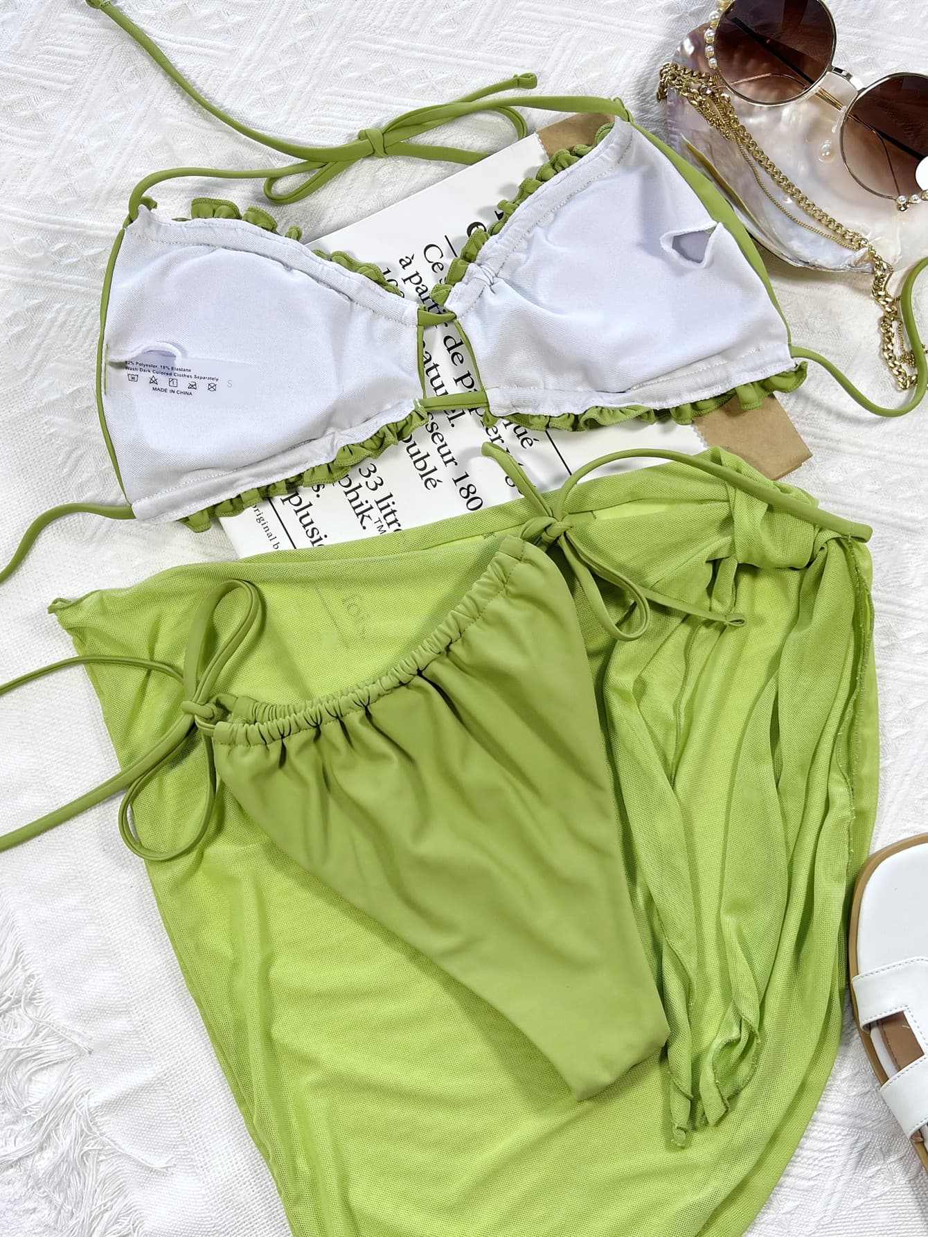 Frill Trill Halter Neck Three-Piece Swim Set in solid green, featuring a tie-side bottom and removable padding.