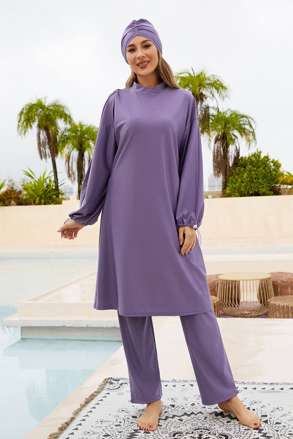 Cap, drawstring mock neck long sleeve top and pants swim set in purple, highly stretchy polyester-spandex blend.