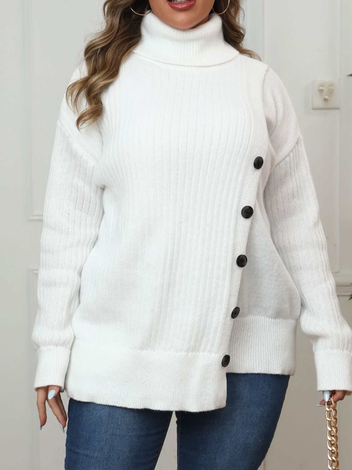 Plus size white turtleneck sweater with long sleeves and black buttons.