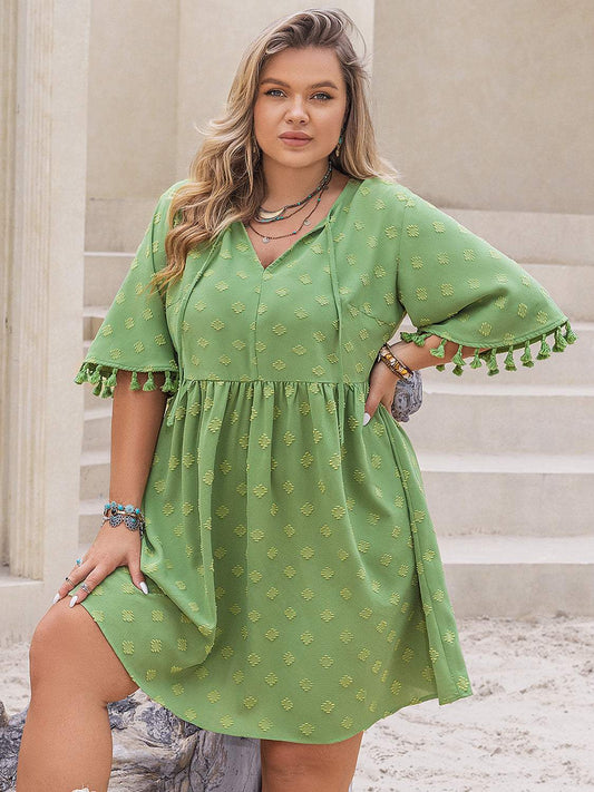 Plus size green tassel mini dress with half sleeves.