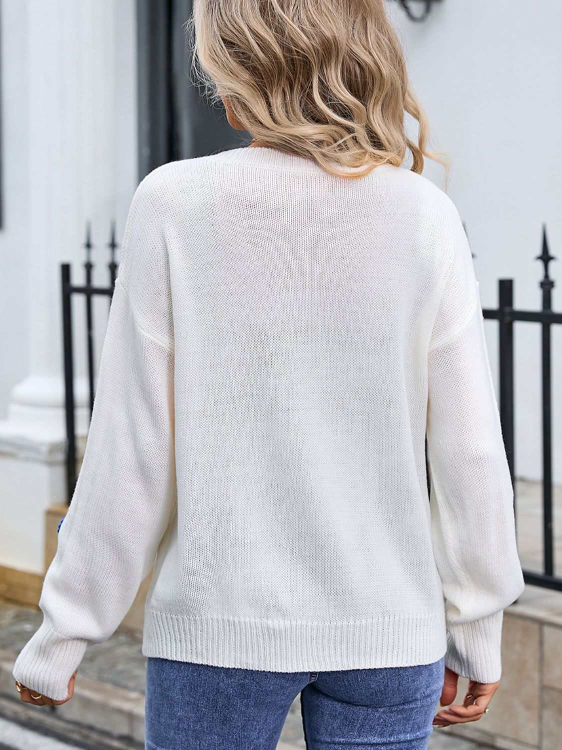 Woman wearing white Angel Wings Crochet Flower Round Neck Sweater with moderate stretch.