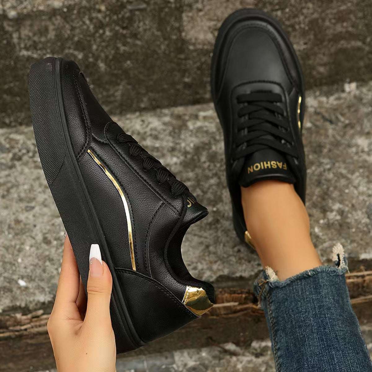 PU leather round toe flat sneakers in black, with rubber sole.