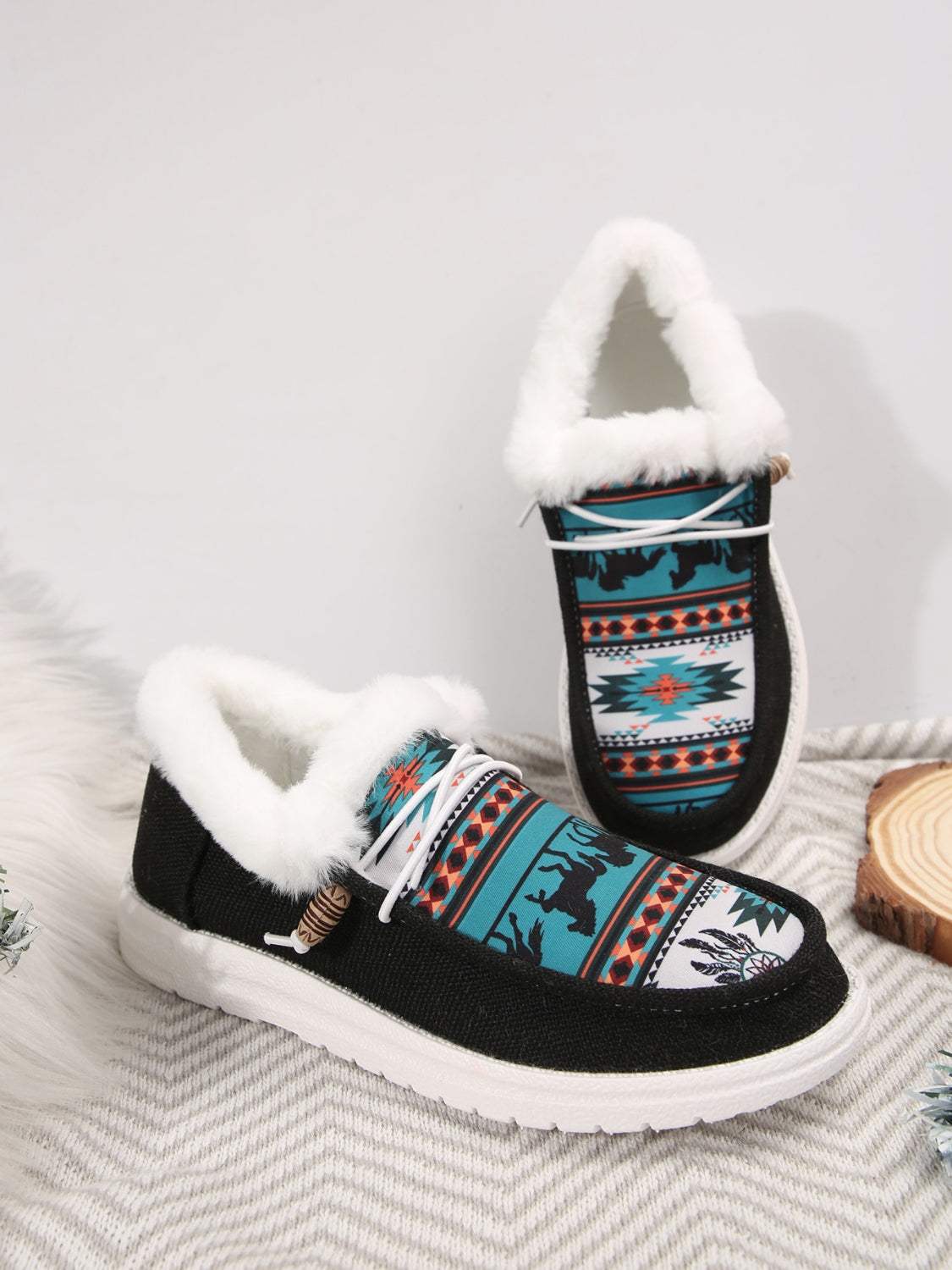 Printed round toe flat slip-ons with faux fur lining and a colorful pattern.