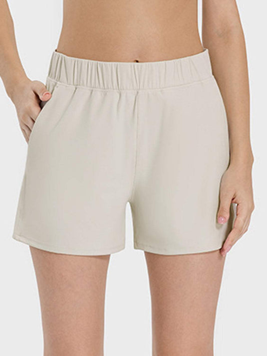 Millennia Elastic Waist Active Shorts with pockets and moderate stretch, nylon-spandex blend.