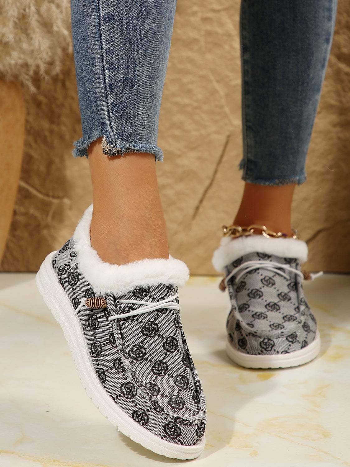 Printed round toe flat slip-ons with faux fur lining and cotton material.