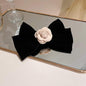 Black bow hair clip with rose trim, alloy, and polyester material.