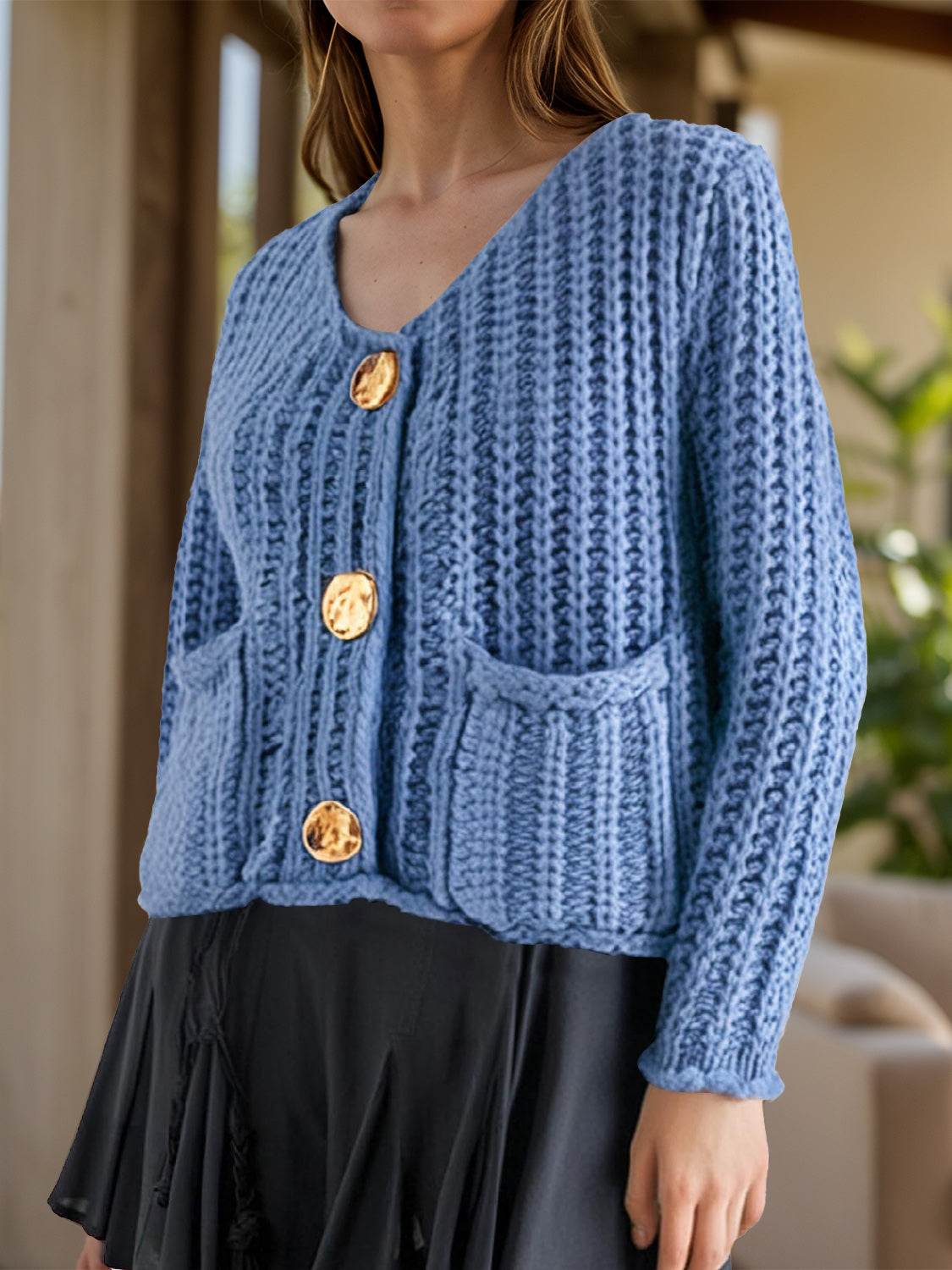 Blue button-down long sleeve cardigan with textured knit design.