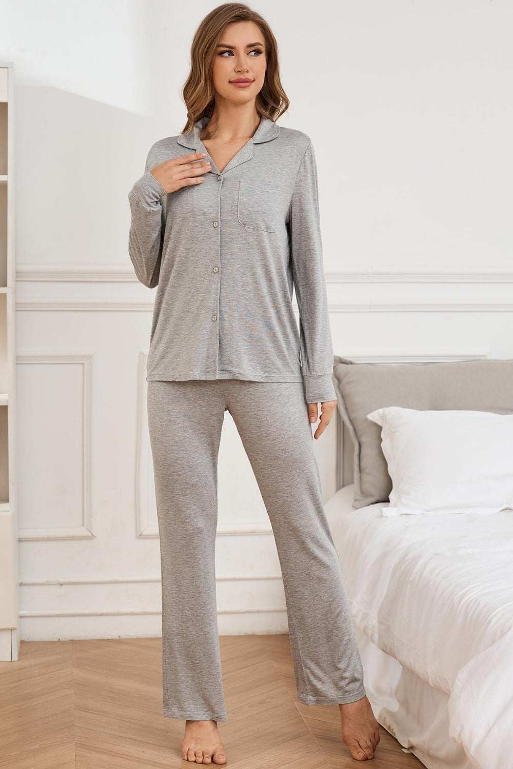 Button up long sleeve top and pants lounge set in gray, shown on a model in a bedroom setting.