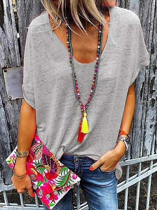 Full Size Scoop Neck Short Sleeve T-Shirt in gray, accessorized with colorful necklace and floral clutch.