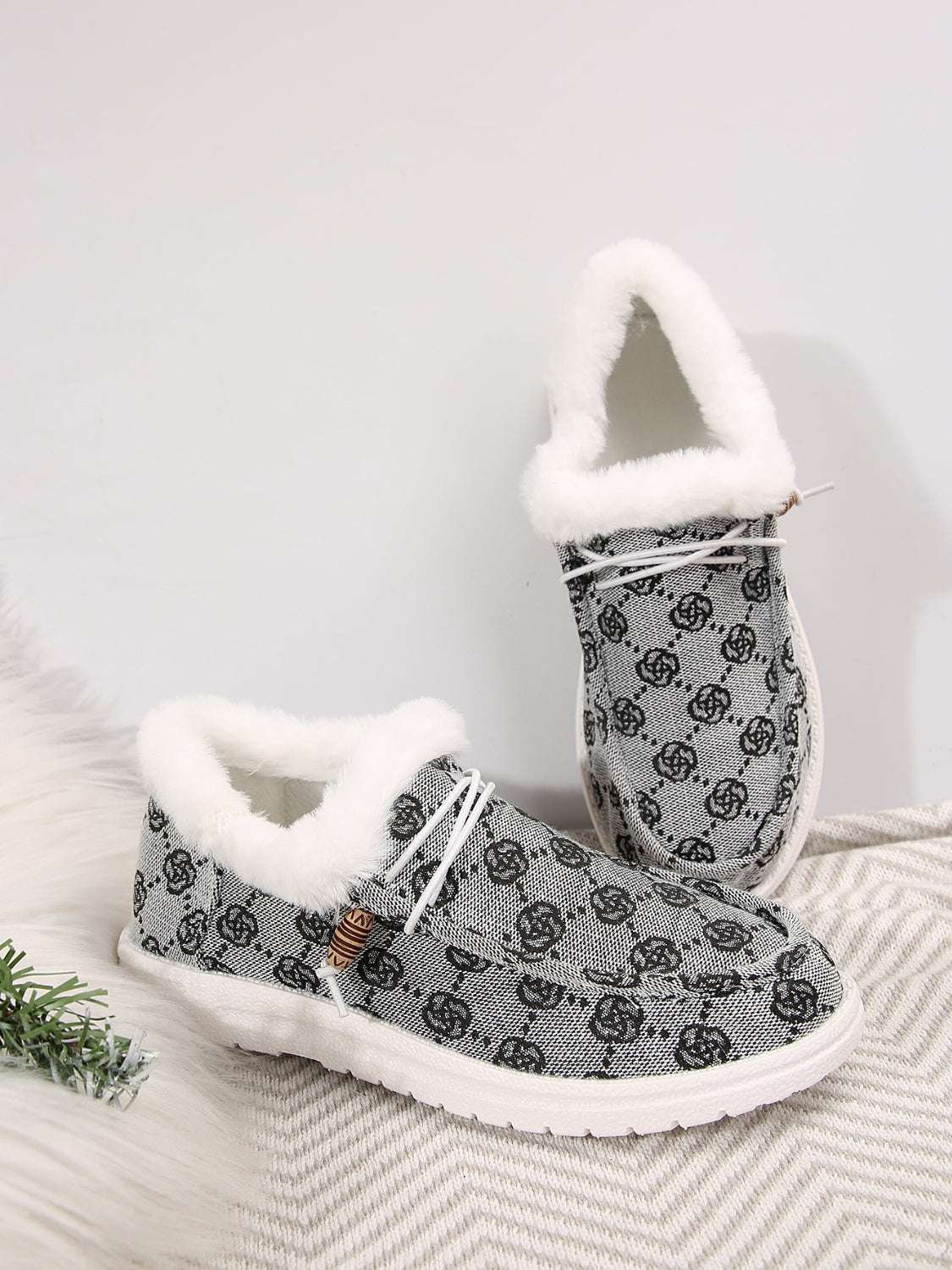 Printed round toe flat slip-ons with faux fur lining and printed design.