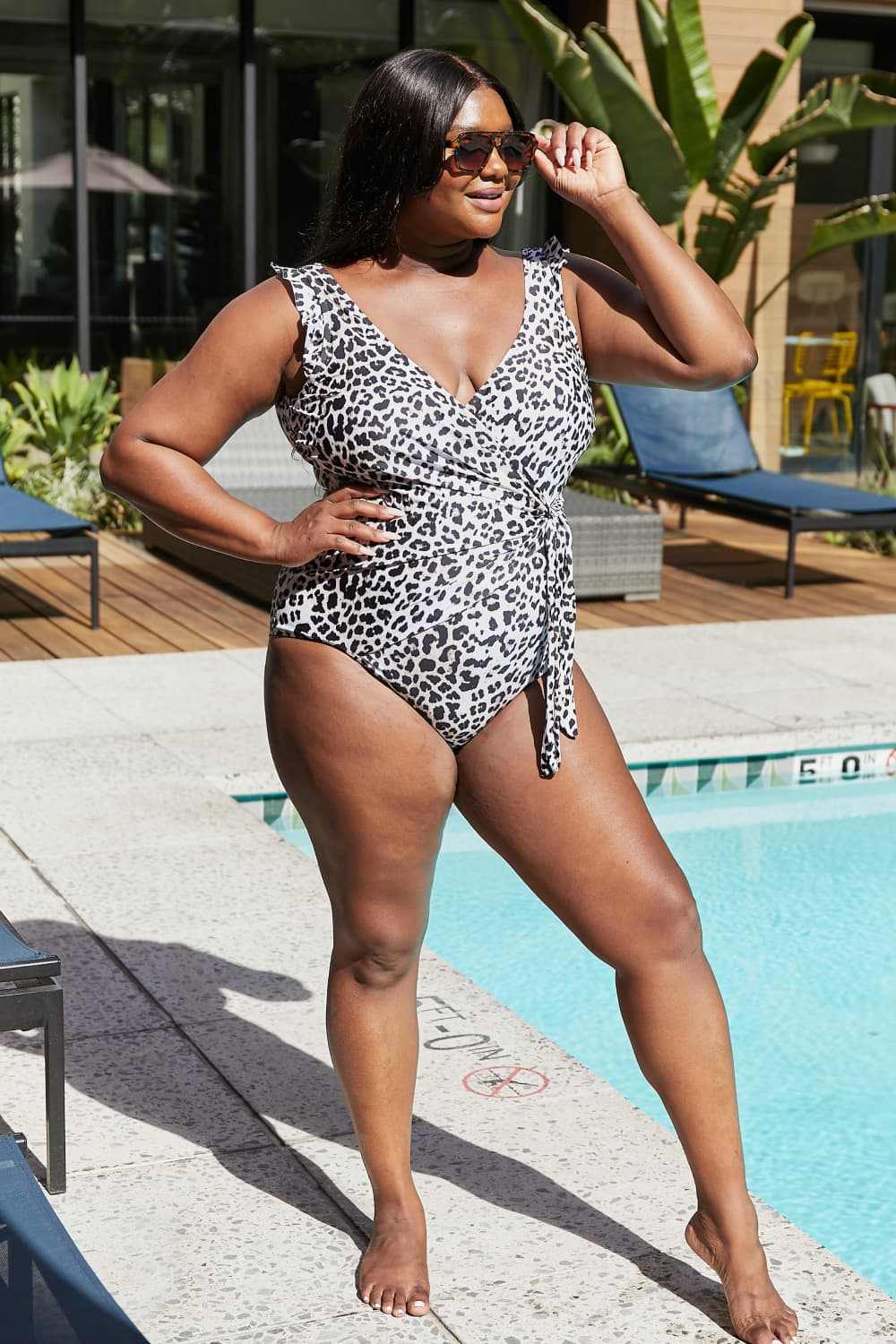 Marina West Swim Full Size Float On Ruffle Faux Wrap One-Piece Leopard Swimsuit, elegant design with surplice neckline and ruffle details.