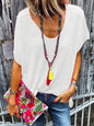 Full size scoop neck short sleeve T-shirt in white, styled with a colorful necklace and floral clutch.