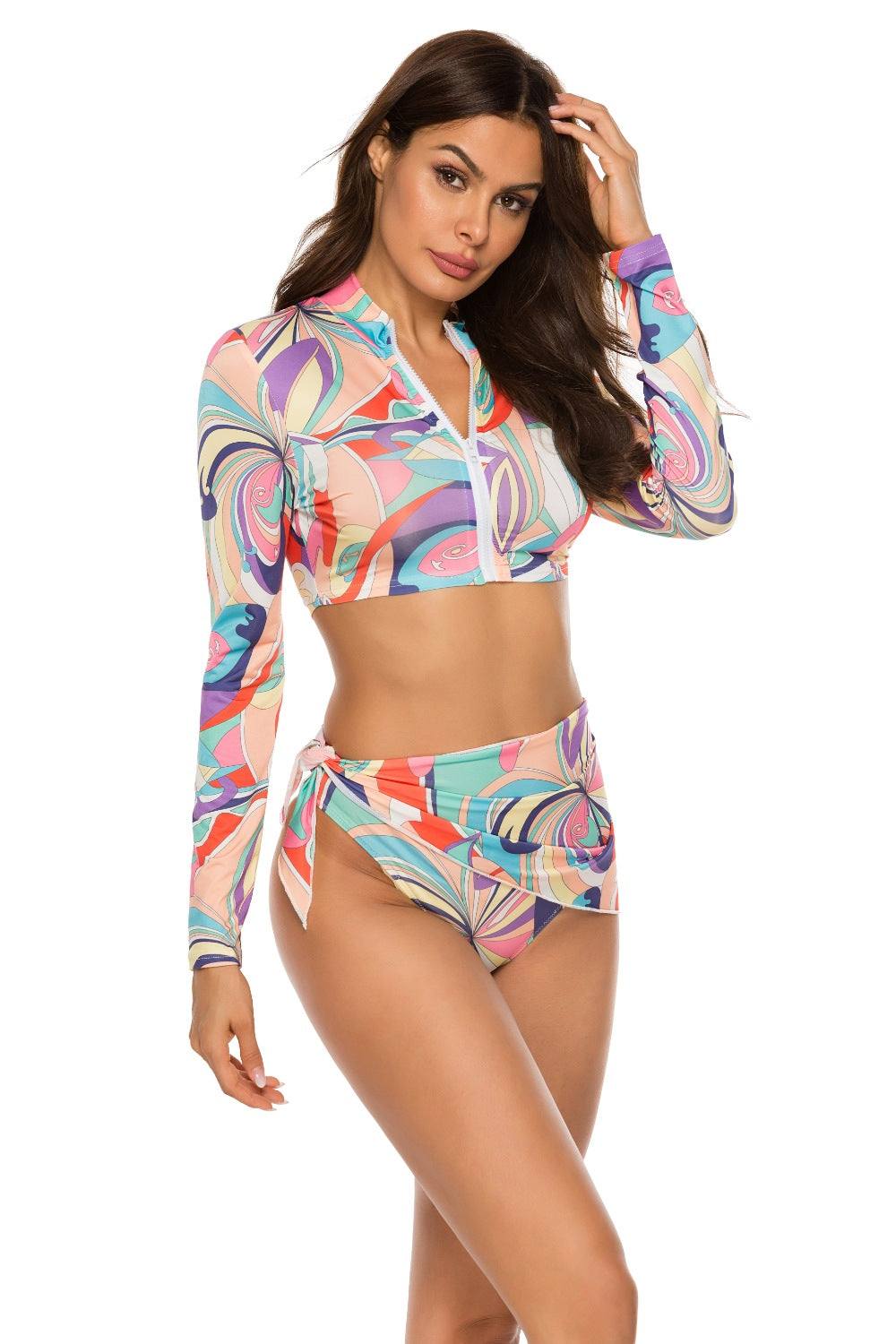 Colorful printed zip-up three-piece swim set with long-sleeve top.