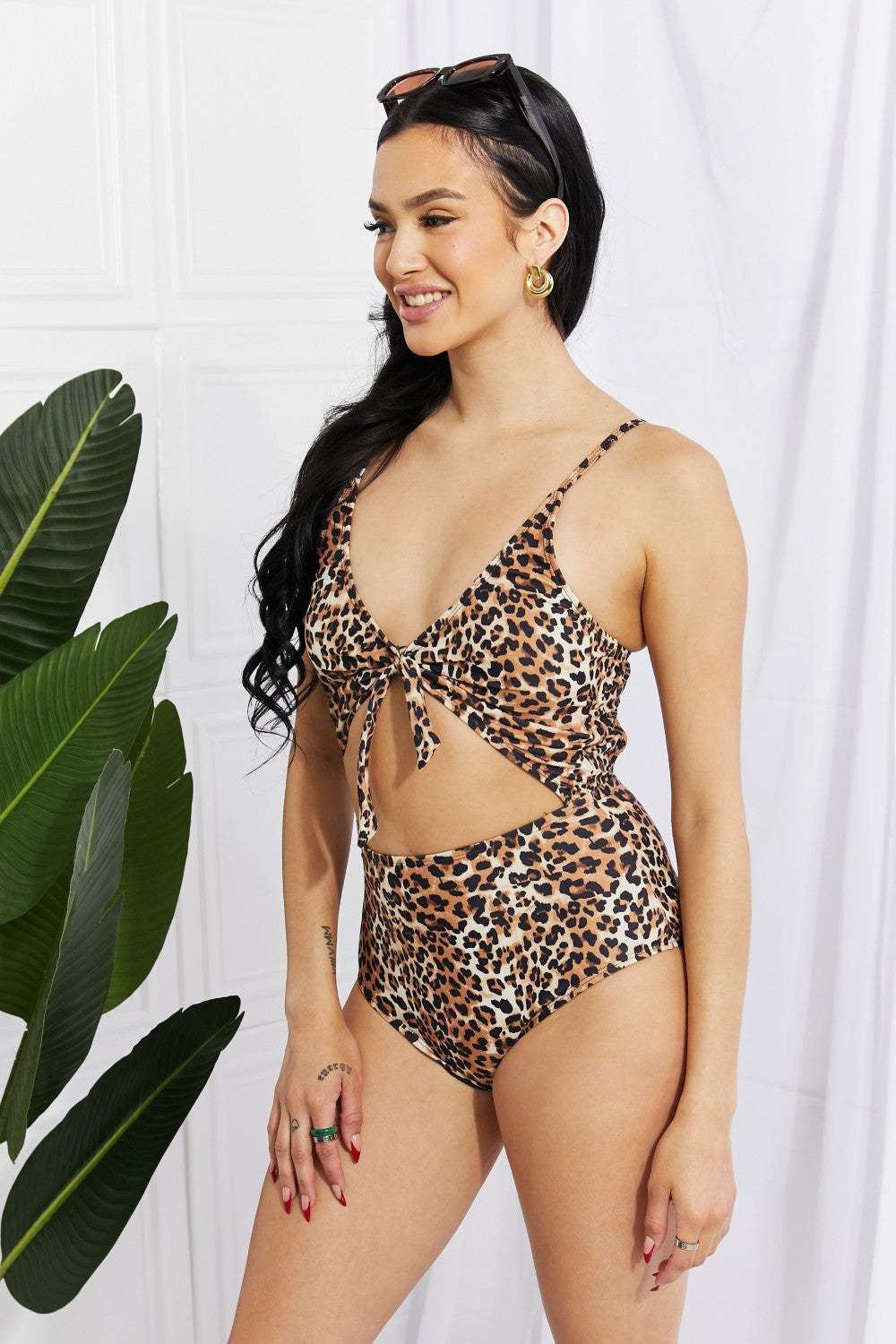 Leopard print cutout one-piece swimsuit by Marina West Swim with plunging neckline.