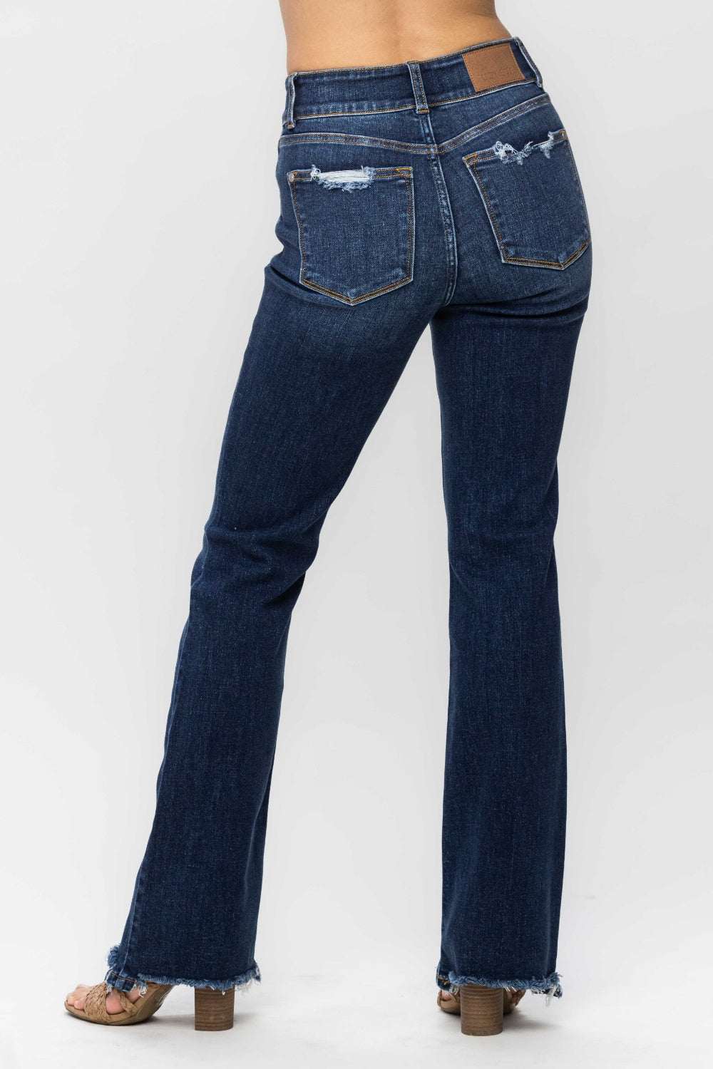 Judy Blue Full Size Frayed Hem Bootcut Jeans with distressed detailing and raw hem.