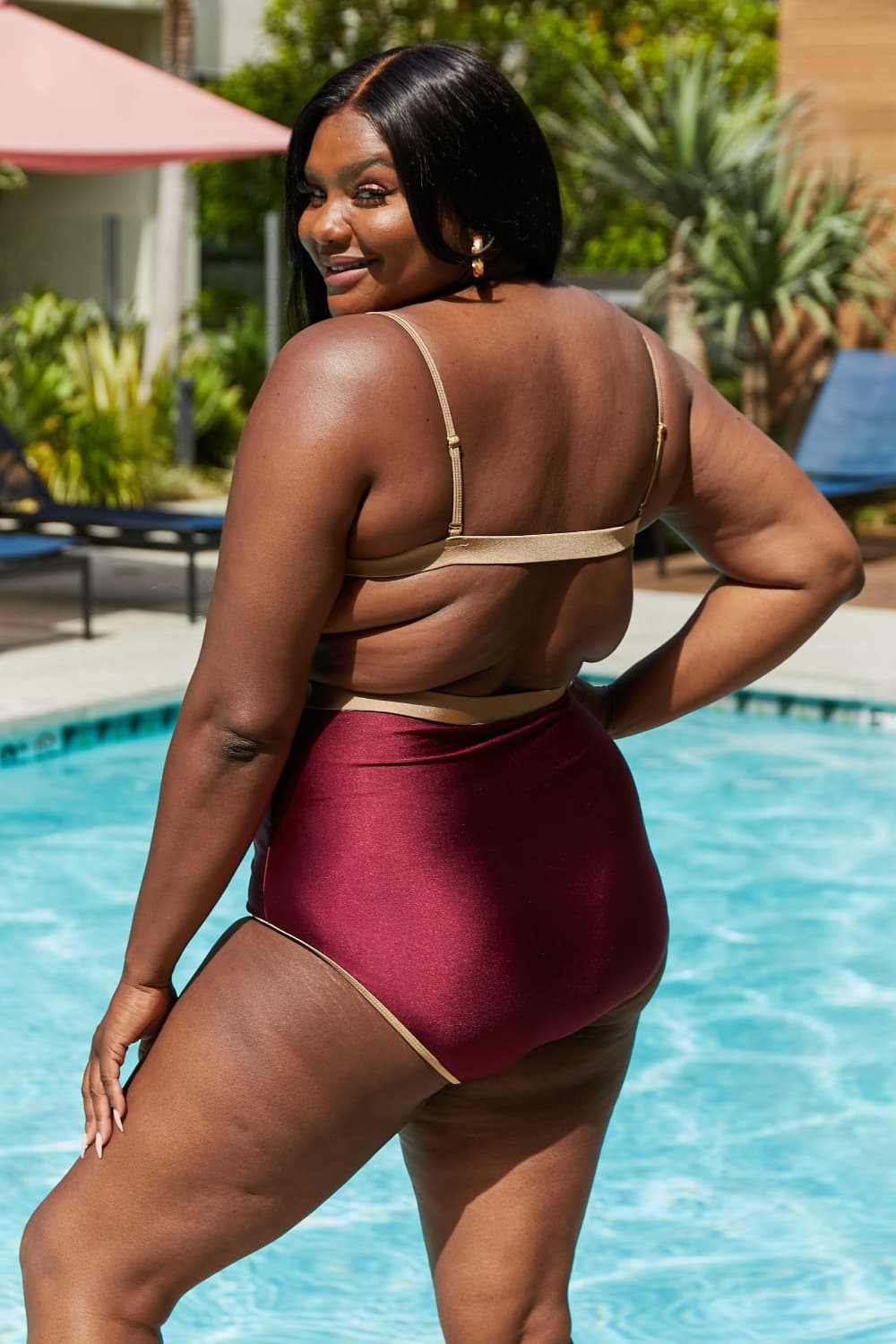 Marina West Swim Wave Break Contrast Trim One-Piece in Wine by the pool.