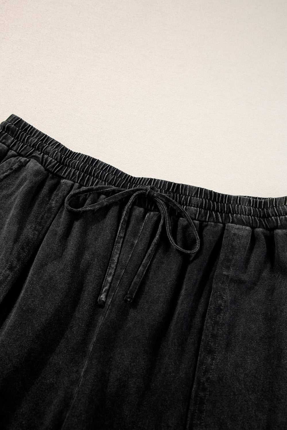 Plus size black drawstring wide leg pants made of 100% cotton.