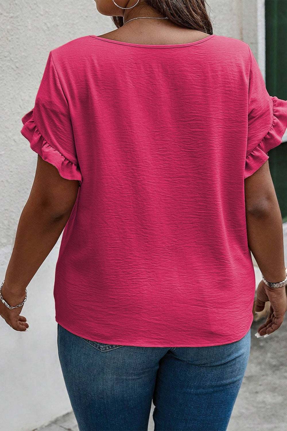 Plus size ruffled round neck short sleeve blouse in pink.