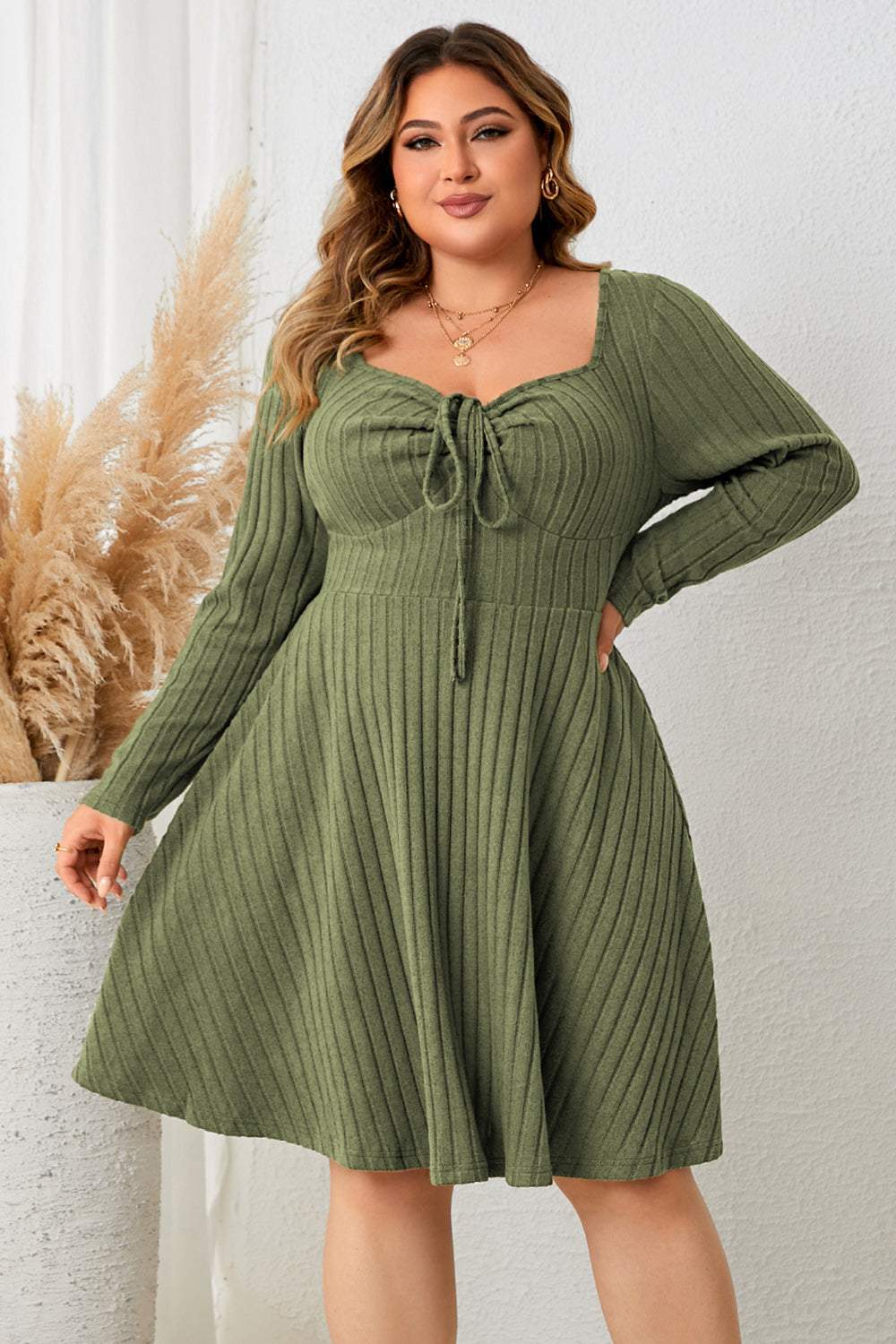 Plus size sweetheart neck long sleeve ribbed dress in green.