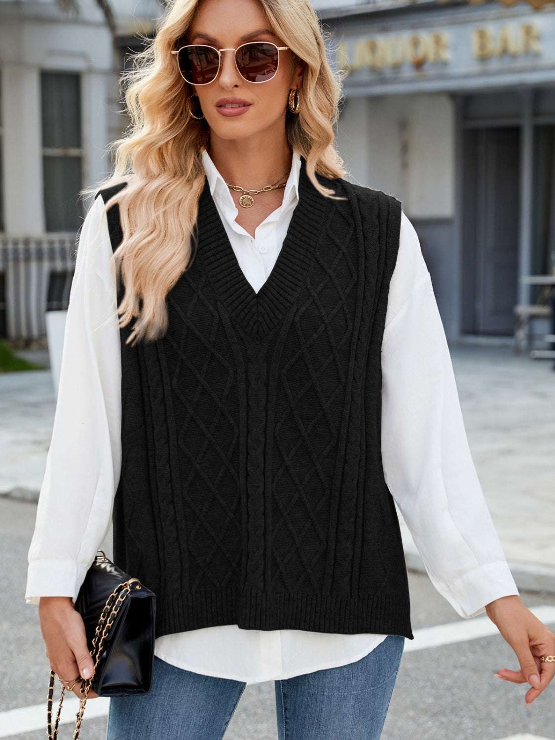 Cable knit V-neck sweater vest in black, slightly stretchy 100% acrylic material.