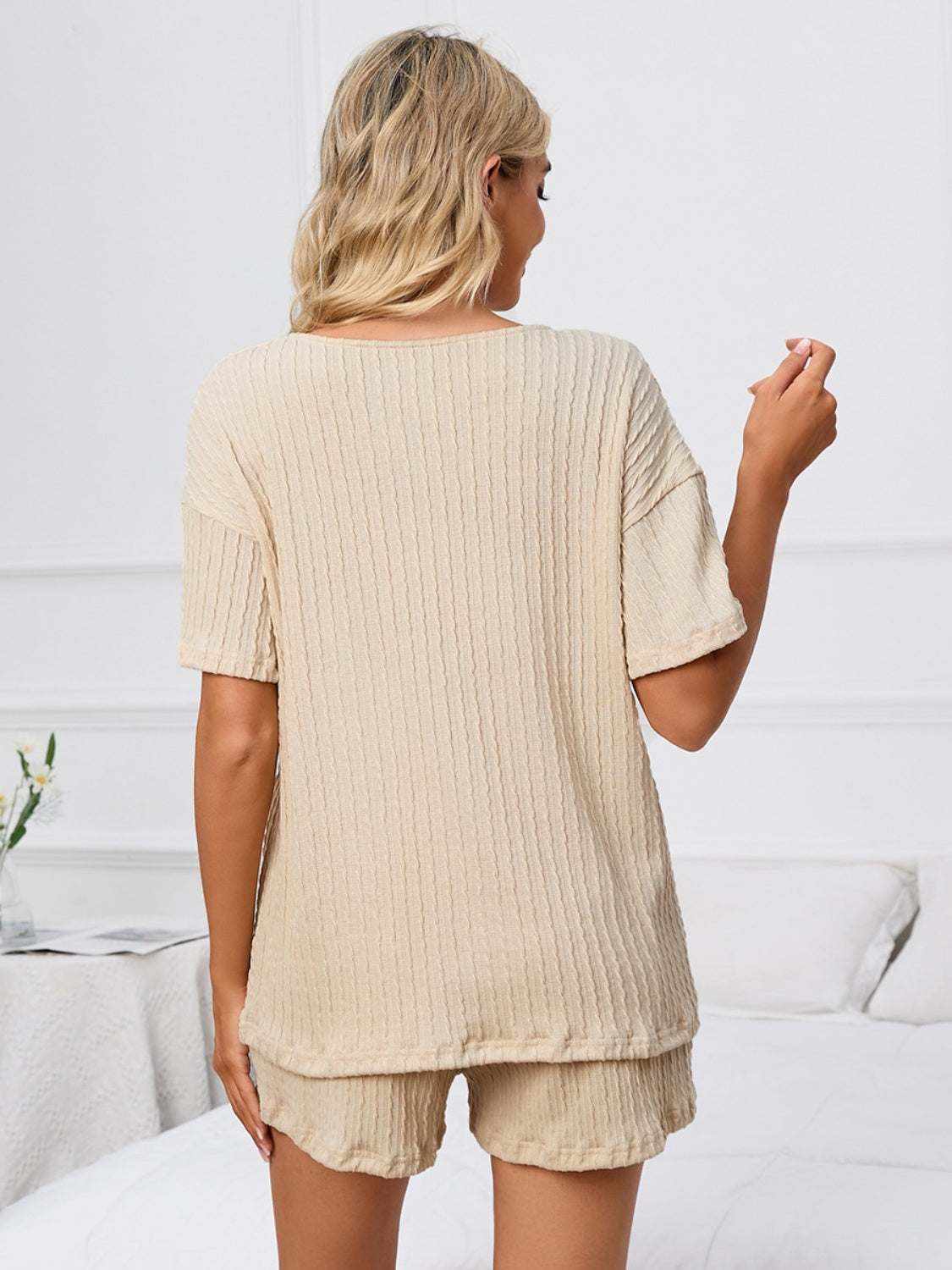 Notched short sleeve and shorts lounge set in beige, ribbed texture, two-piece, slightly stretchy fabric.