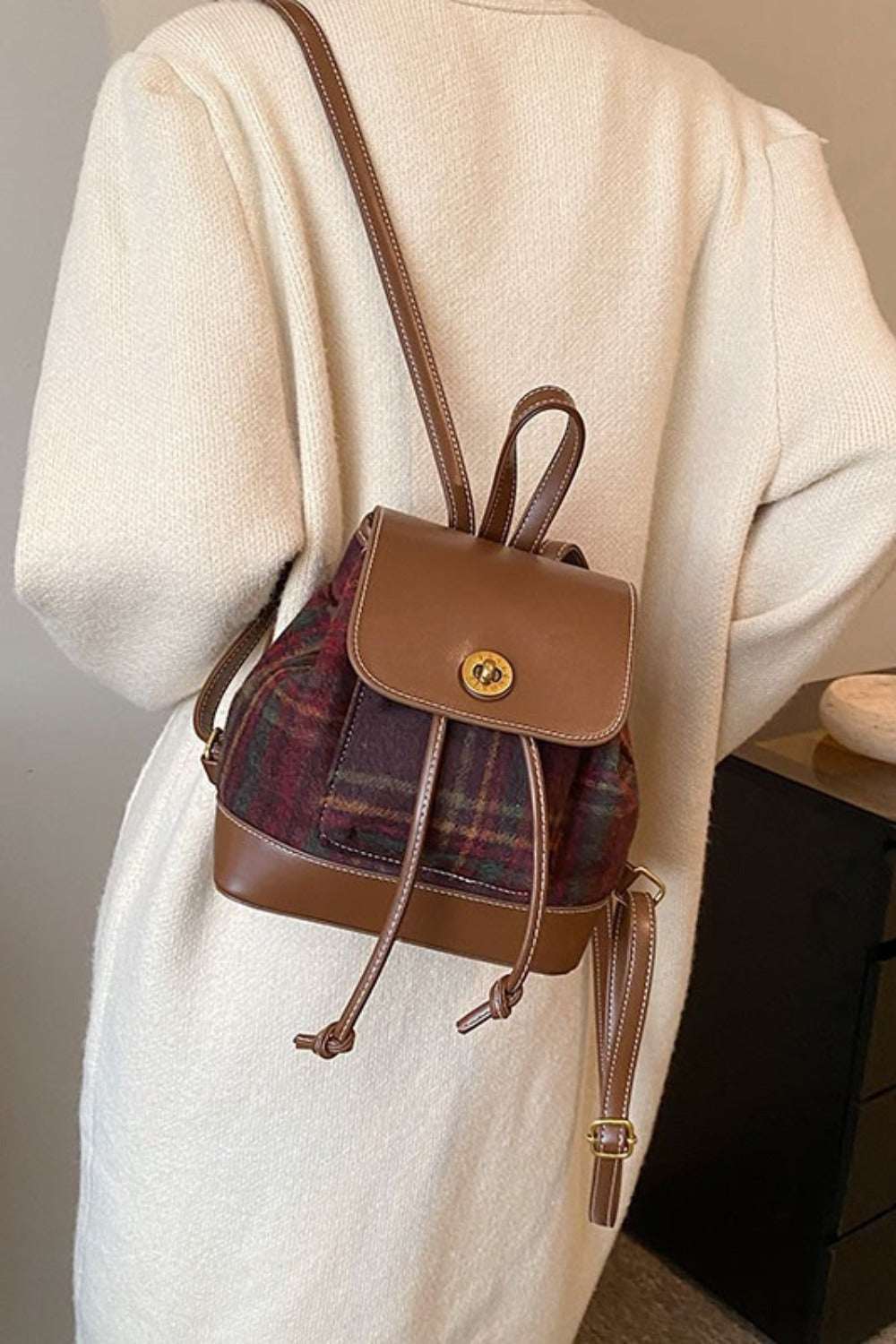 PU Leather Drawstring Plaid Backpack Bag in brown and plaid design on model.