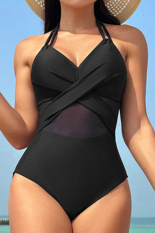 Crisscross halter neck one-piece swimwear in black with removable padding.