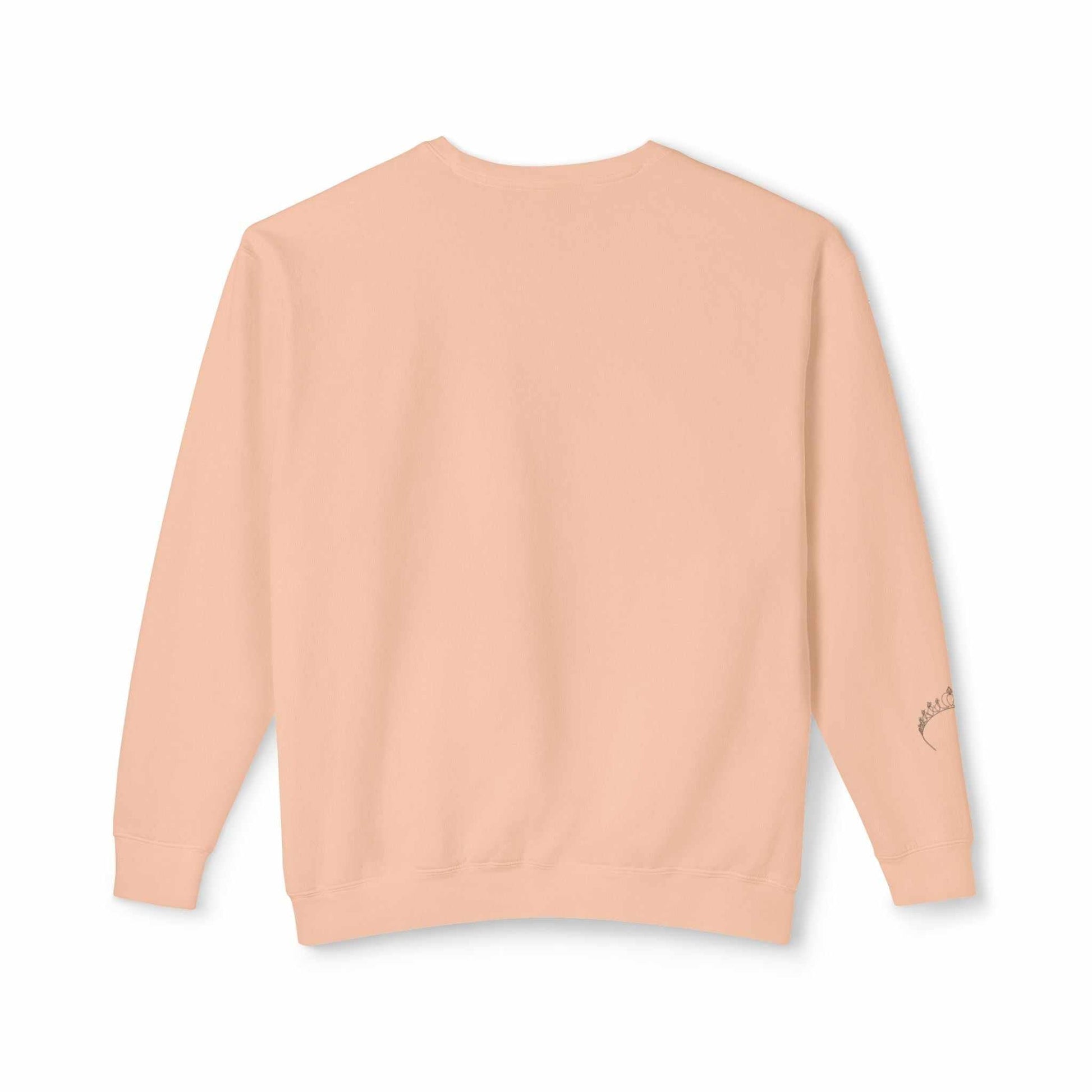 Back view of Queens Mystery Sweatshirt in peach color, showcasing relaxed fit and ribbed cuffs.