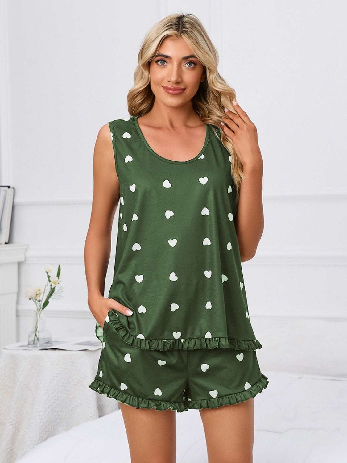 Green heart scoop neck tank and shorts lounge set with white heart patterns.