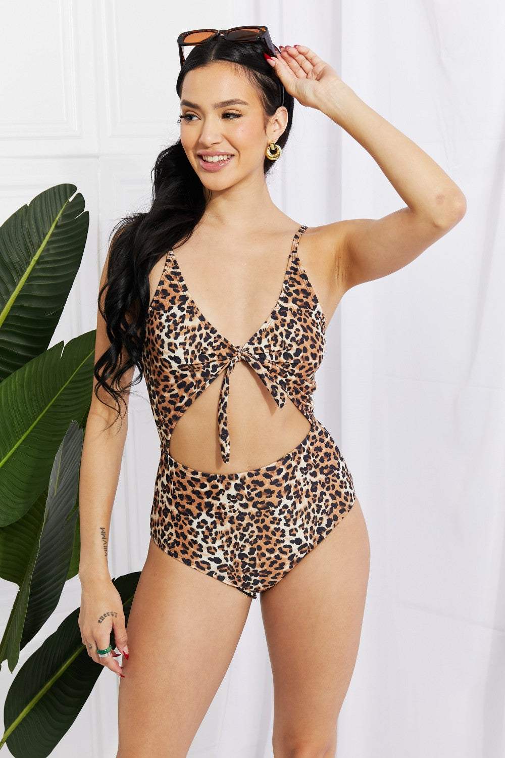 Leopard print cutout one-piece swimsuit with plunging neckline by Marina West Swim.