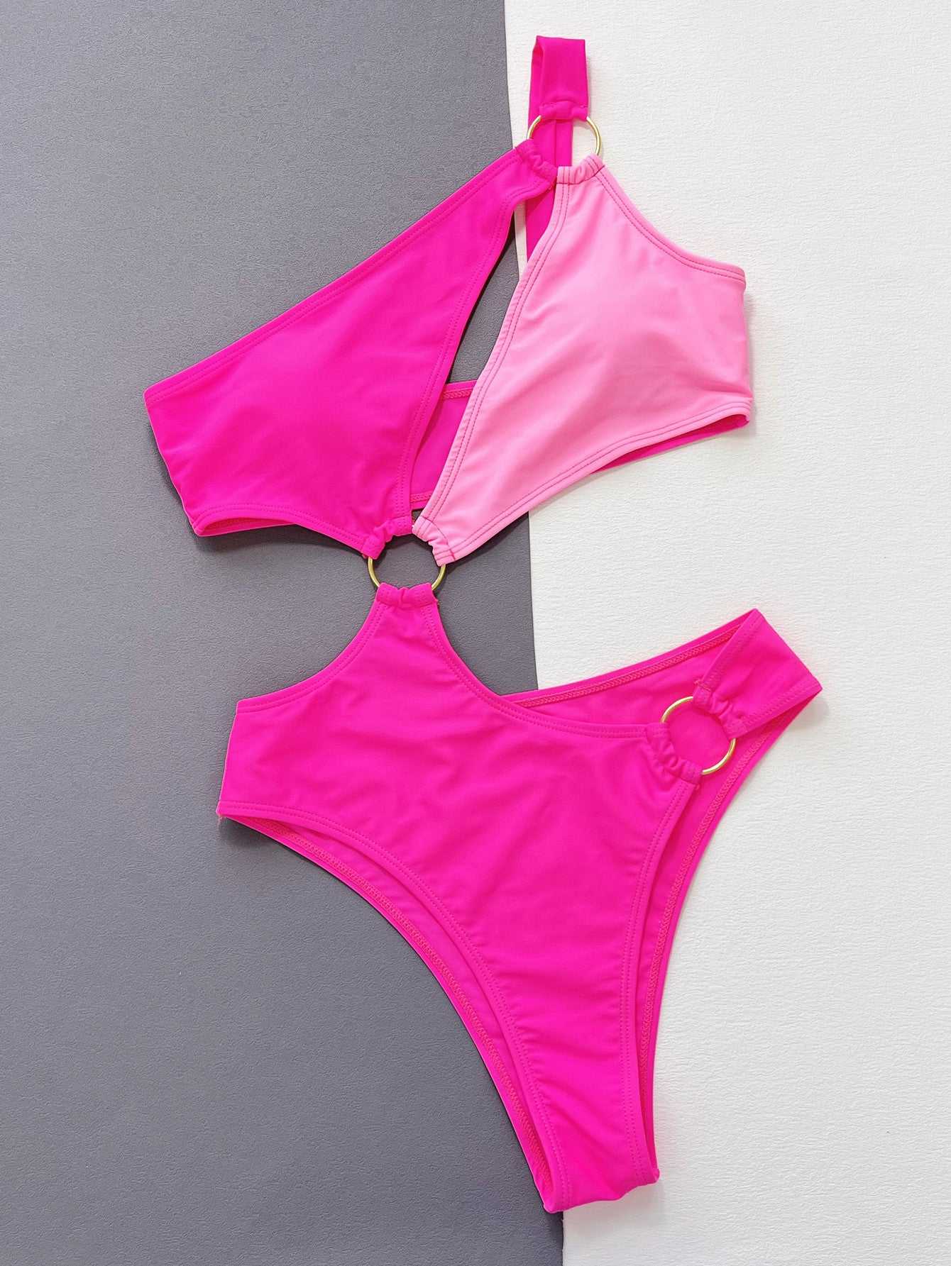 One-Shoulder Cutout Ring Detail One-Piece Swimsuit in pink and light pink with contrast pattern.