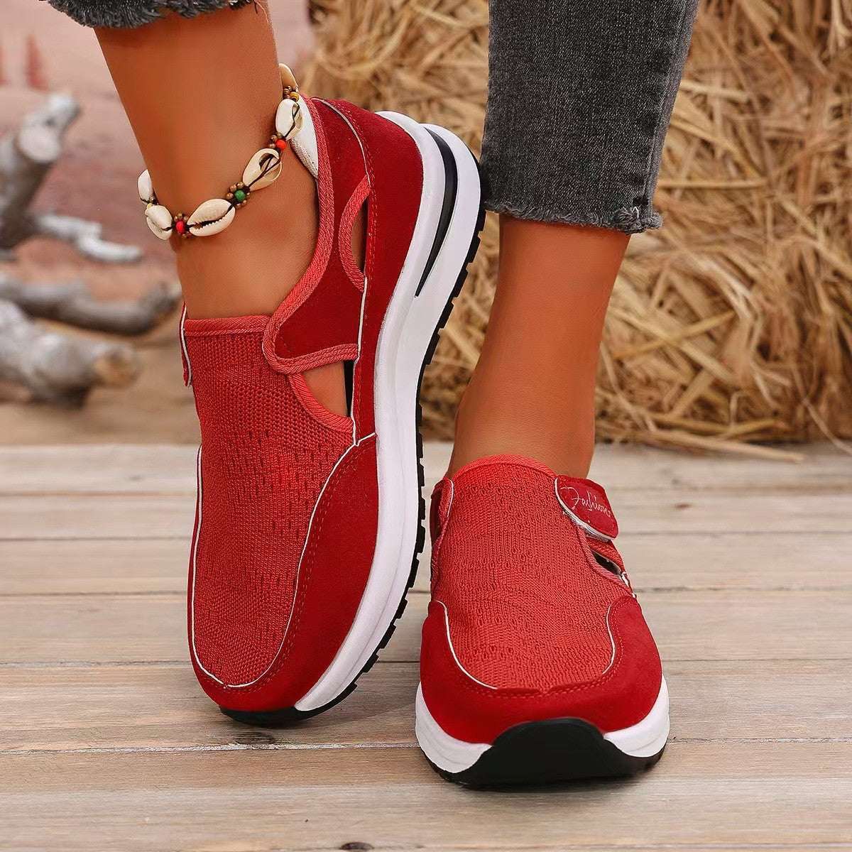 Red mesh round toe platform sneakers with mid heels and rubber sole.