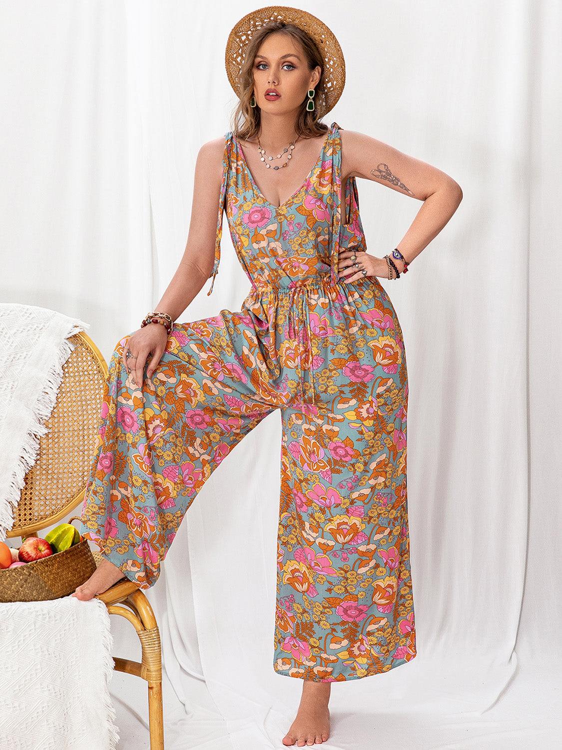 Plus size printed wide leg sleeveless jumpsuit with floral design, tied straps, and backless style.