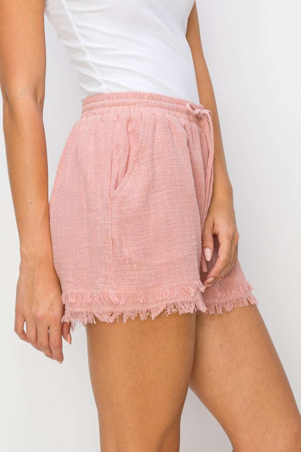 HYFVE Drawstring Frayed Shorts in pink with pockets and raw hem, ideal for casual wear.