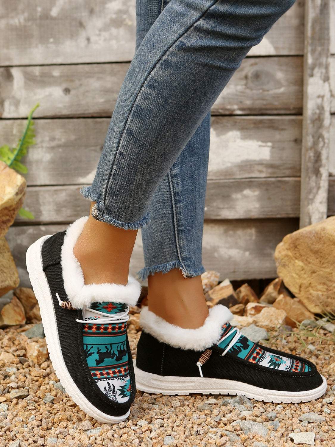 Printed round toe flat slip-ons with faux fur lining and colorful patterns.