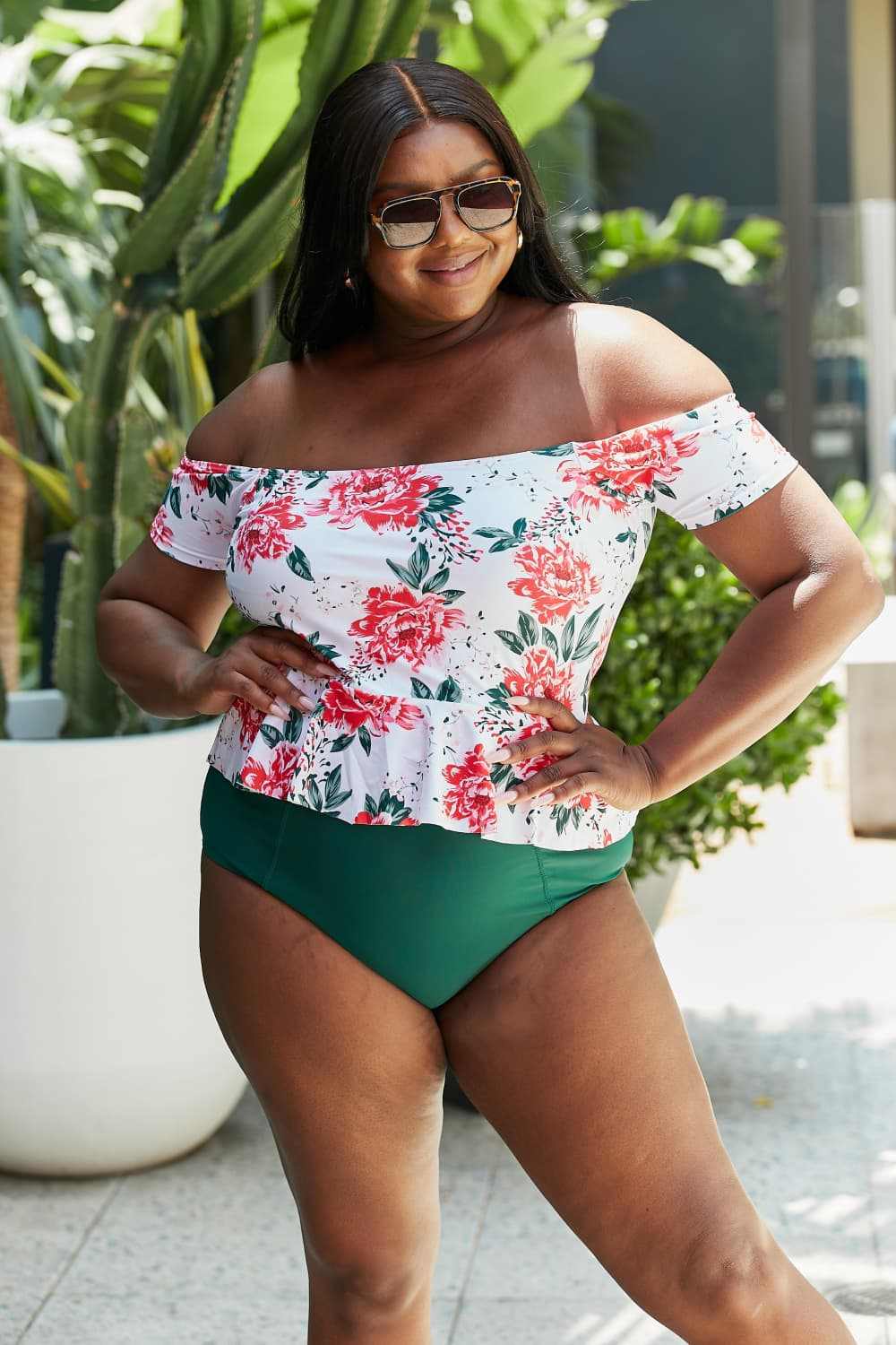 Plus-size woman wearing Marina West Swim Coastal Cutie floral tankini swimsuit with high-waisted bottoms.