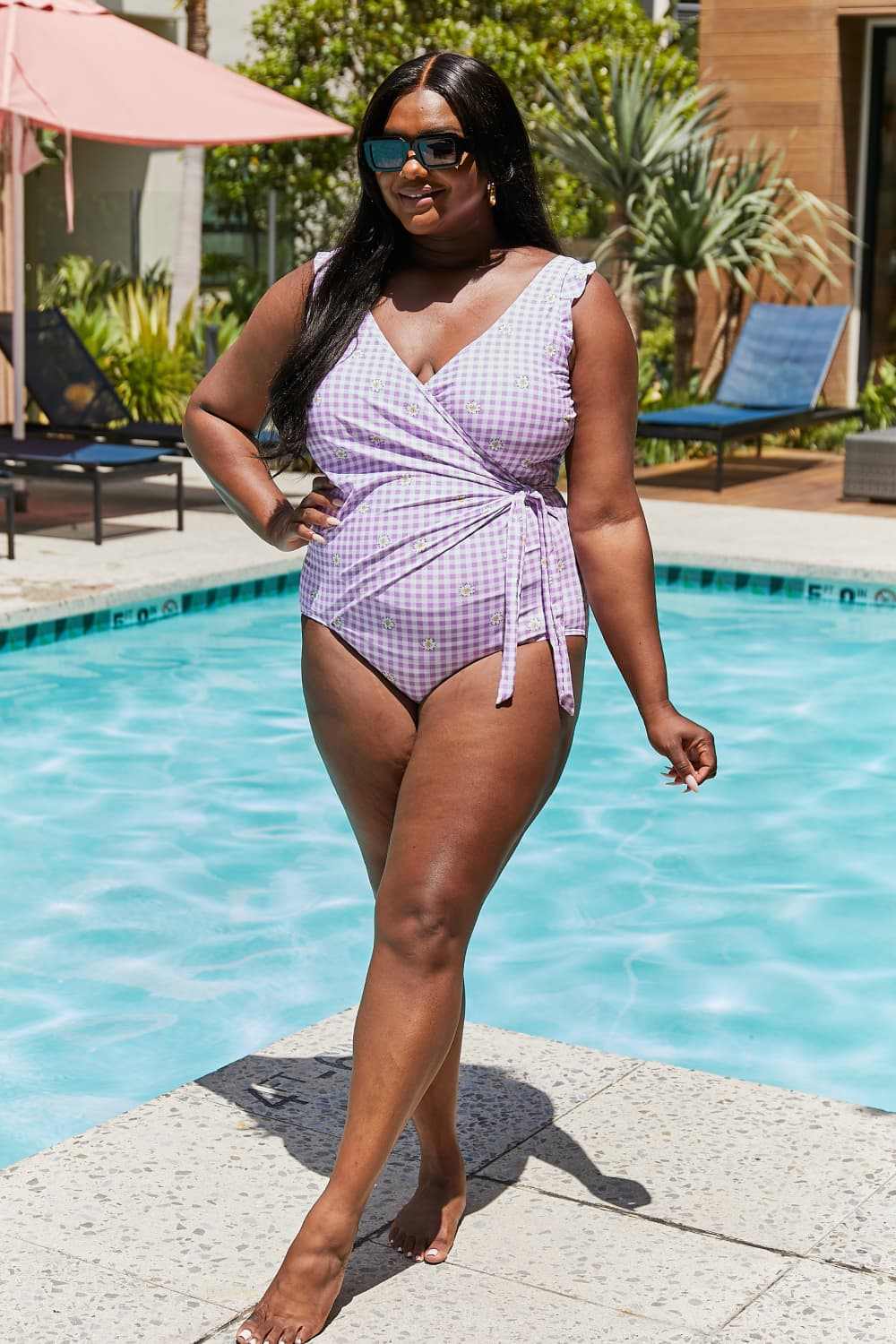 Marina West Swim Full Size Float On Ruffle Faux Wrap One-Piece in Carnation Pink by the pool.