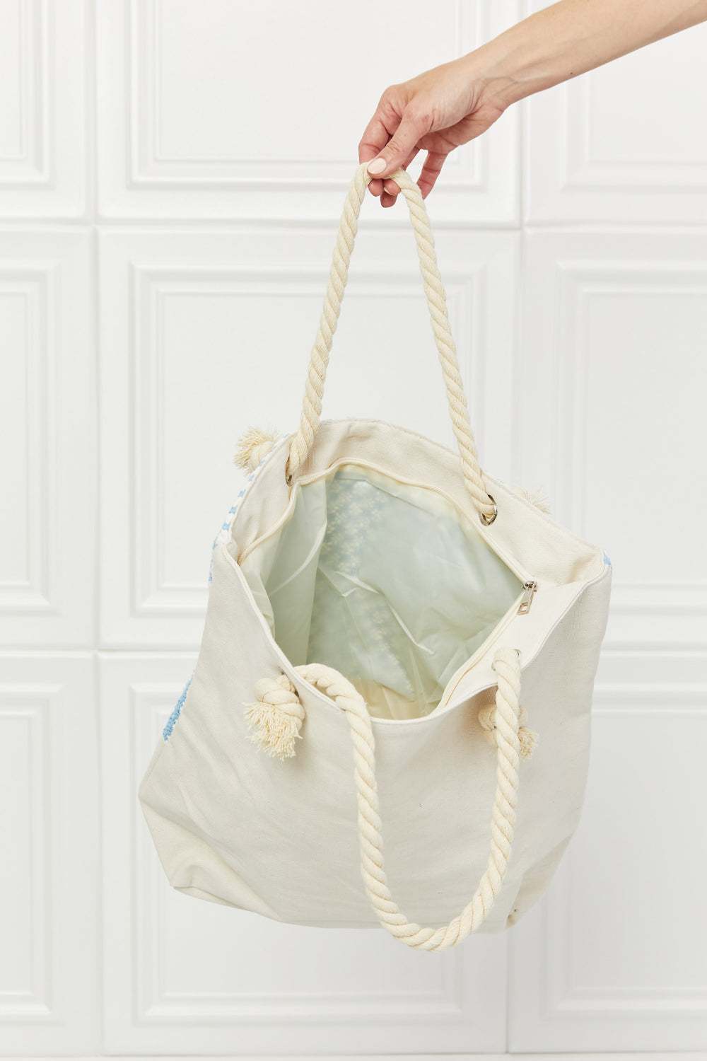 Justin Taylor Picnic Date Tassel Tote Bag with rope handles and plaid pattern, shown open to reveal spacious interior.