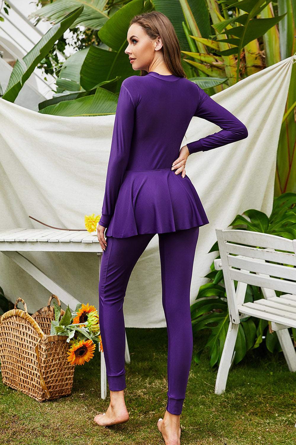 Mock neck long sleeve one-piece swimwear in purple with flared waist and leggings.