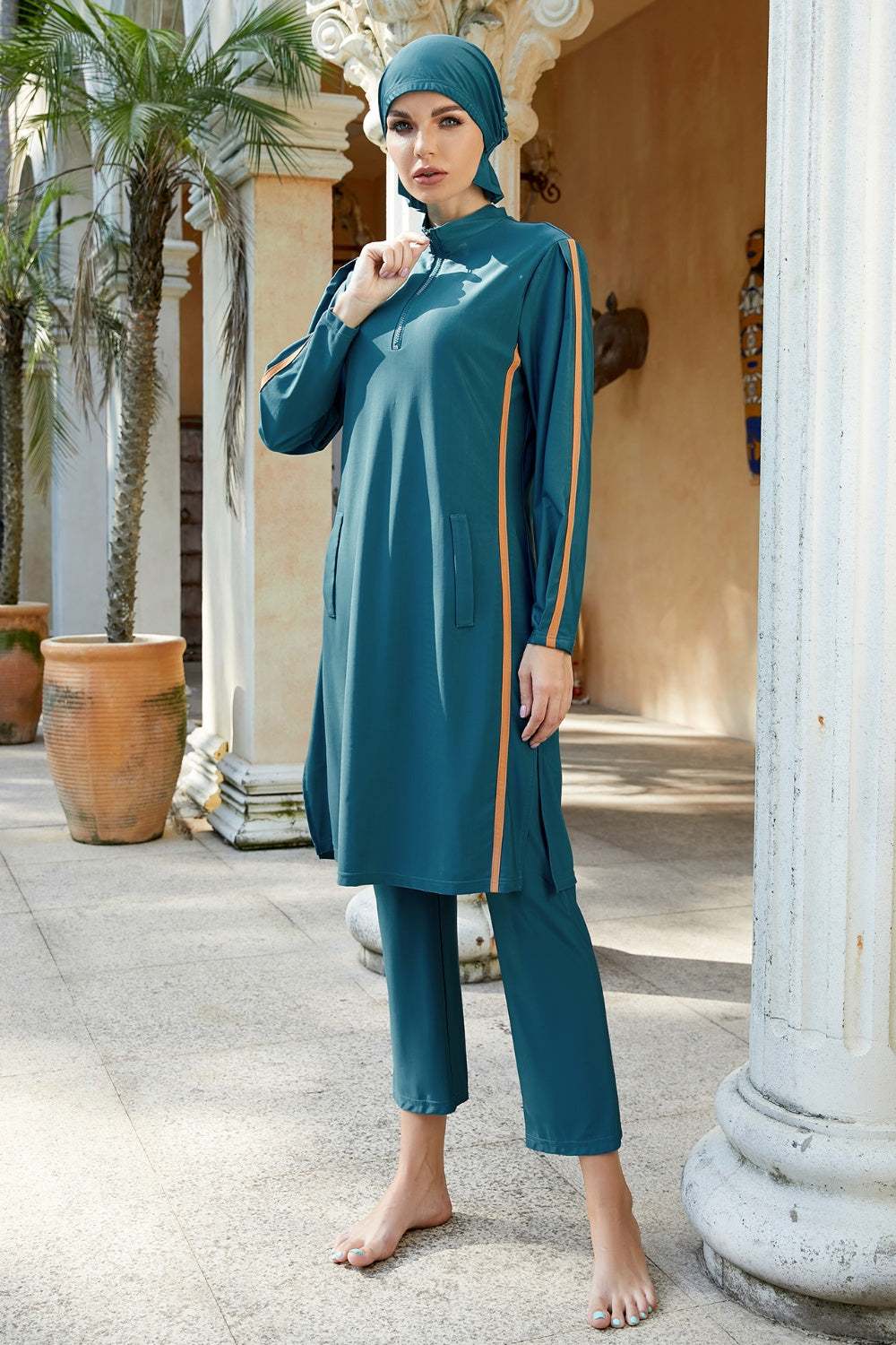 Three-piece swim set with cap, quarter zip top, and pants; highly stretchy polyester-spandex blend.