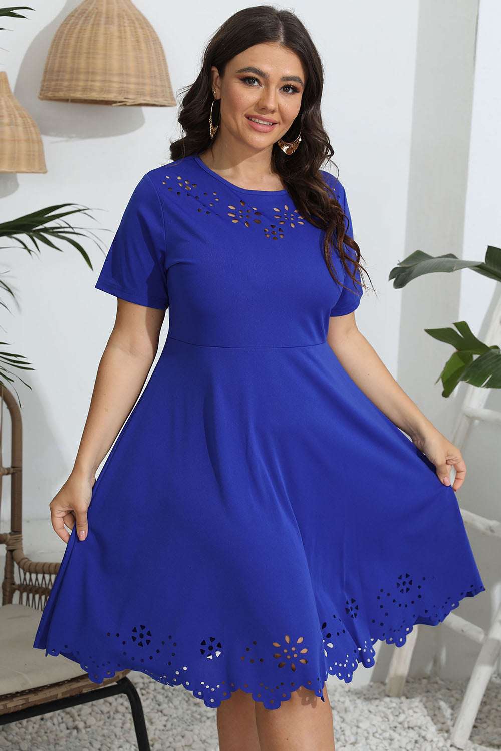 Plus size round neck openwork dress in blue with short sleeves and decorative cutouts.