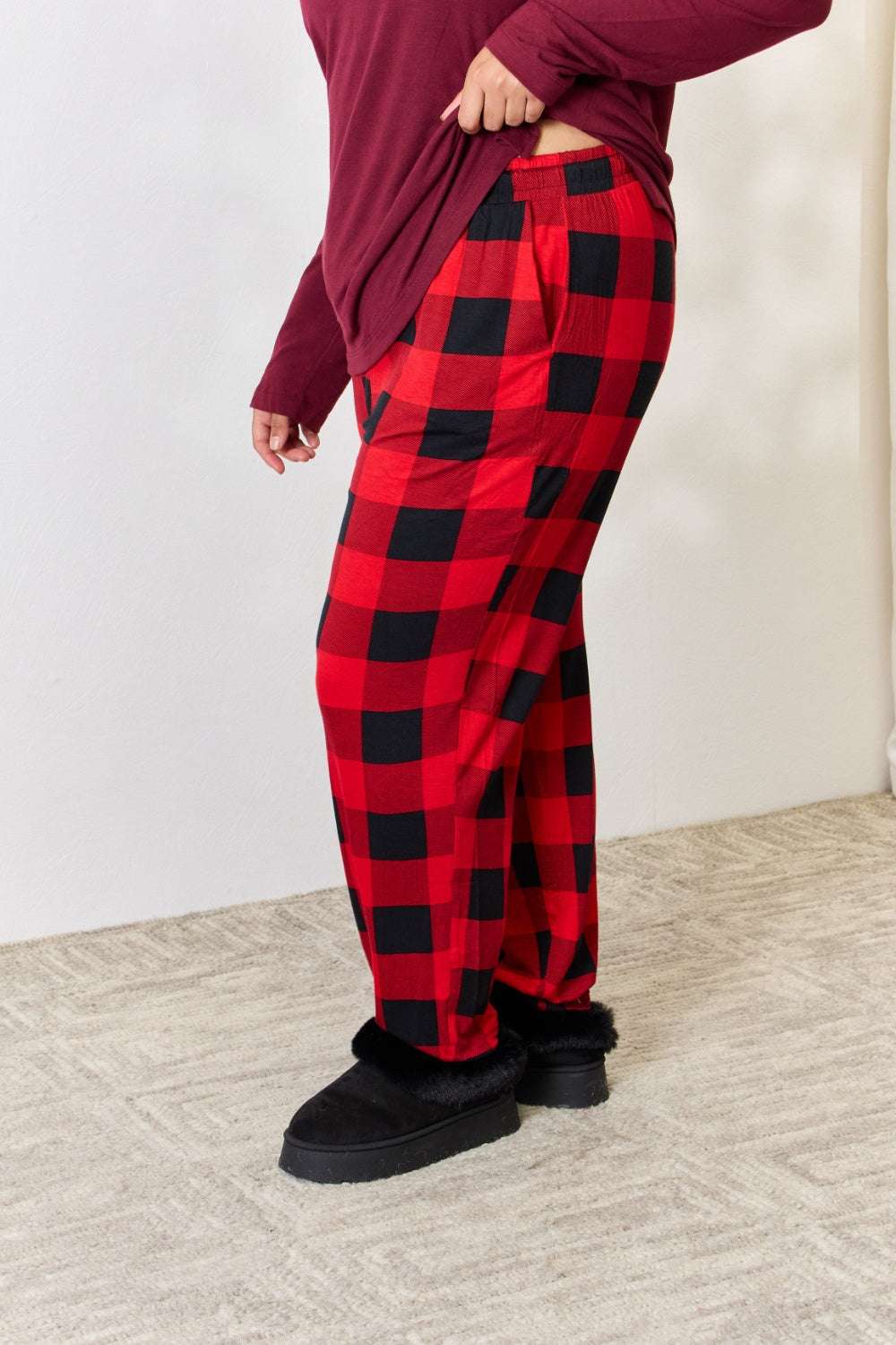 Zenana full size plaid round neck top and pants pajama set, featuring a cozy fit with an elastic waist and pockets.