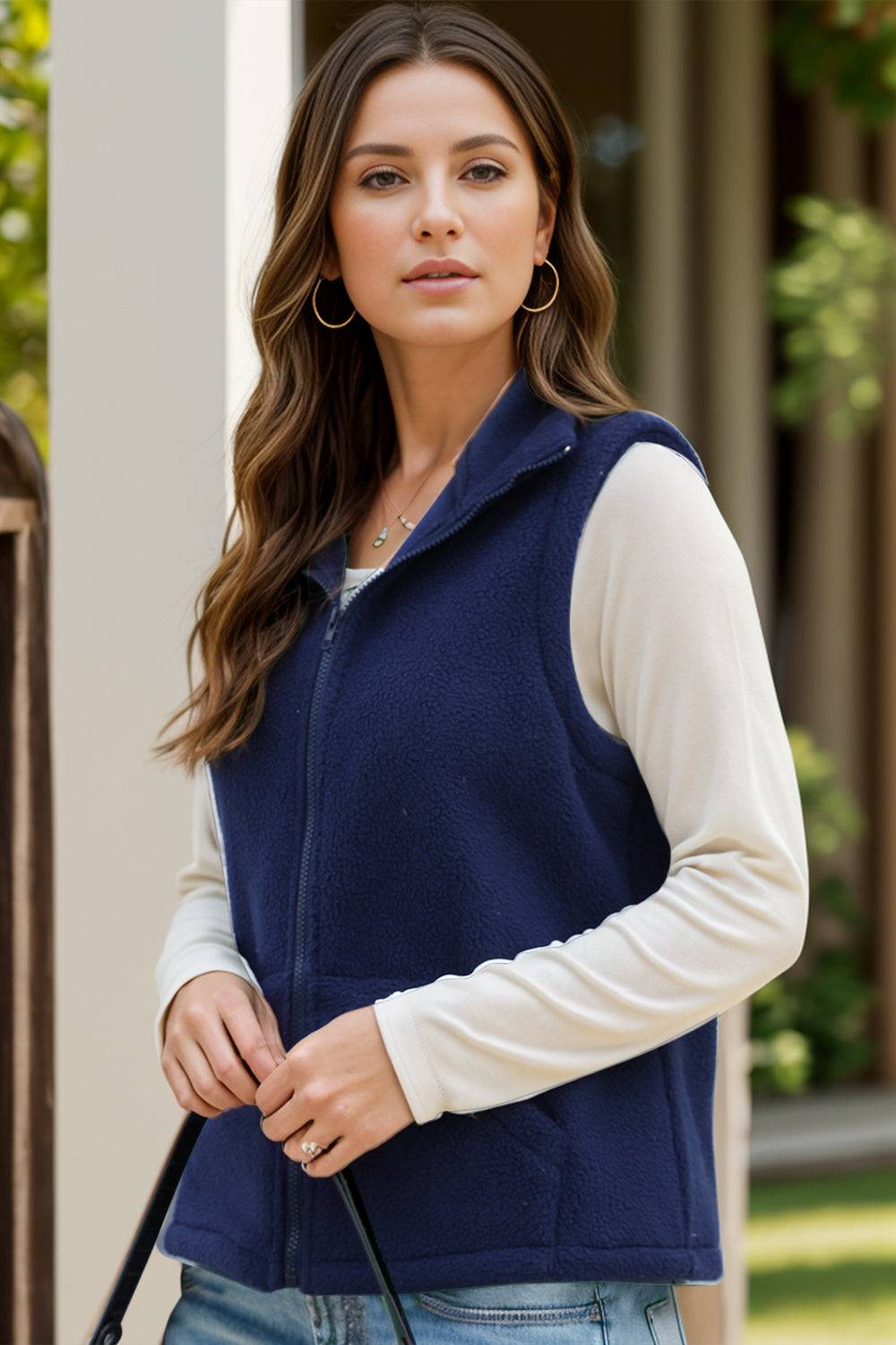 Naval blue zip-up vest coat with pockets, polyester-spandex blend.