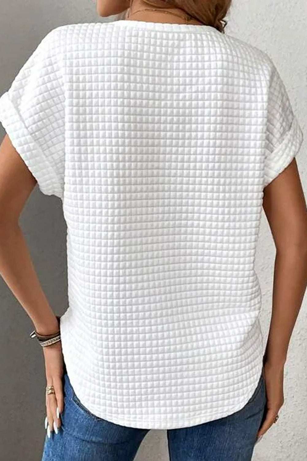 Round neck short sleeve white t-shirt with a textured pattern.